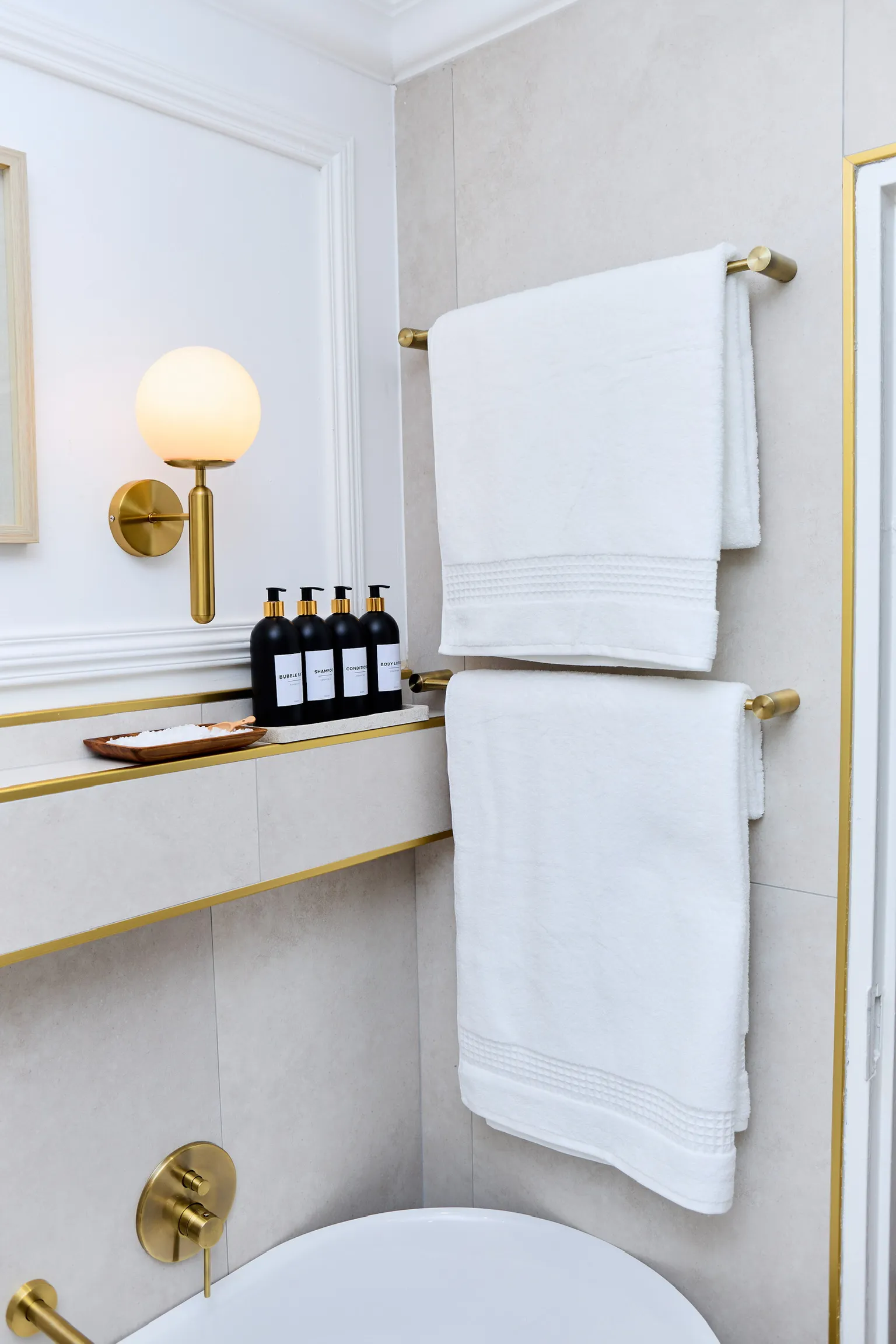 The Golden Bathroom — brass sconce and bath products